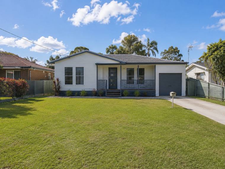 Australian family home with a garage and a wide front lawn